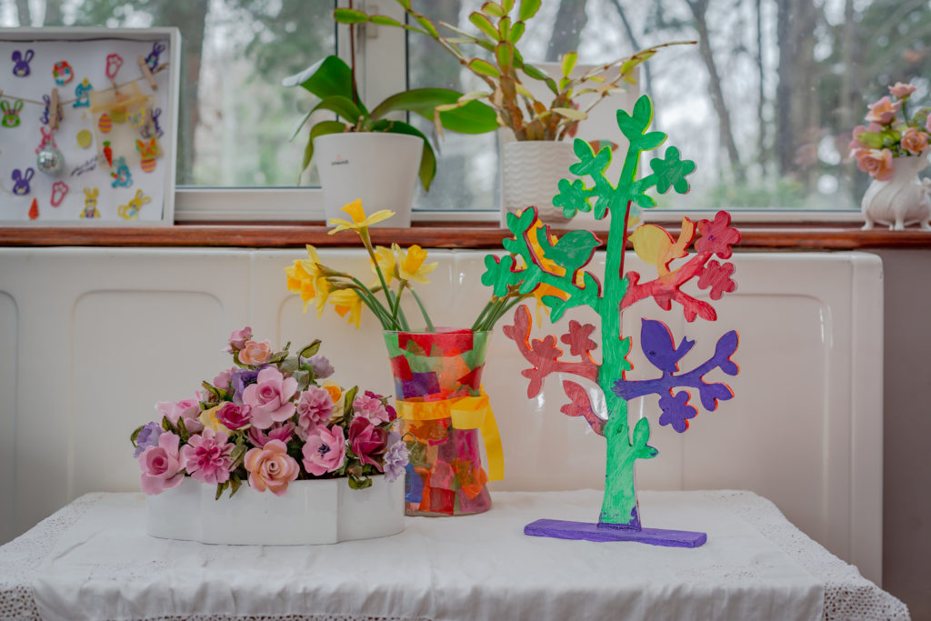 small decorations on a desk in front of a window