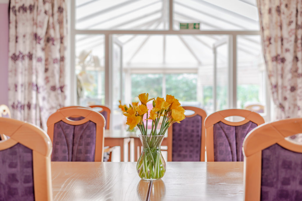 daffodils sat on a communcal table at a care home