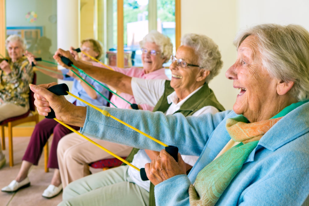 elderly people exercising at a care home