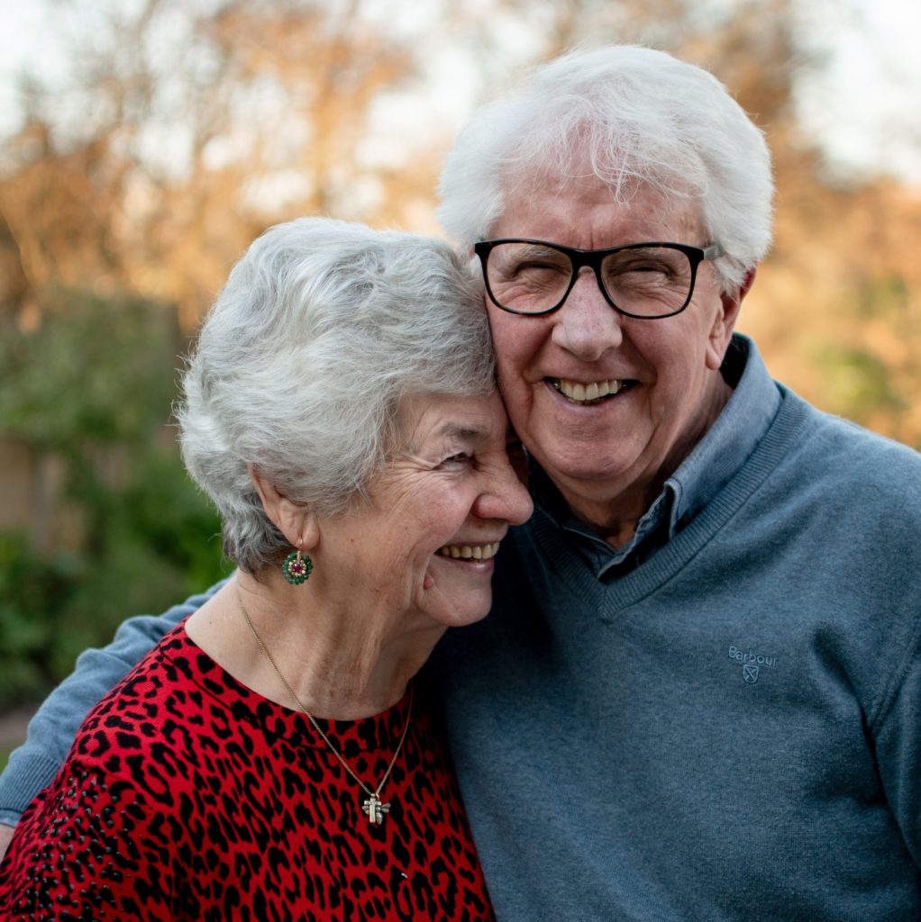 elderly couple embracing at a care home