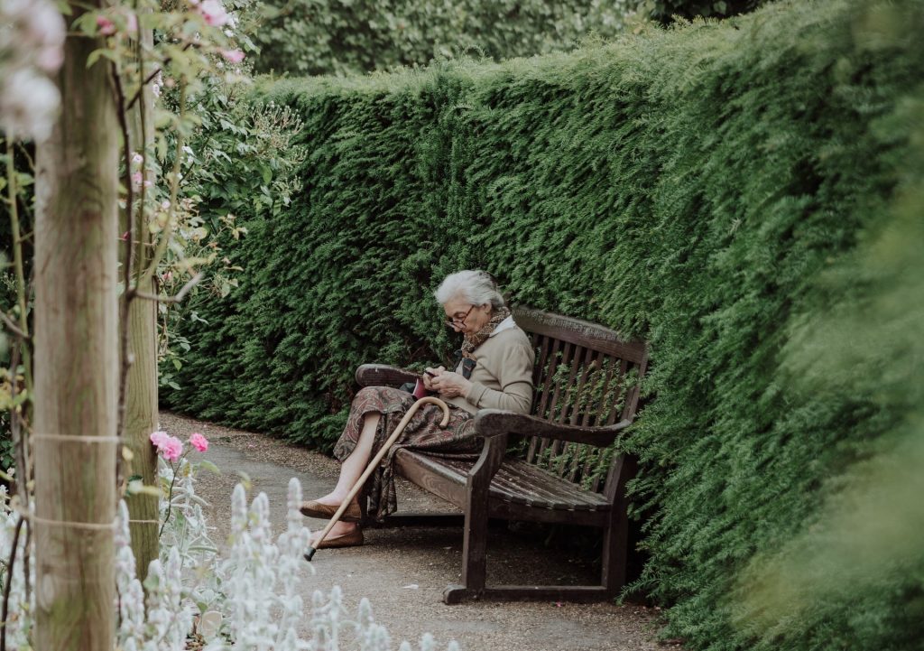 elderly woman sat on a bench