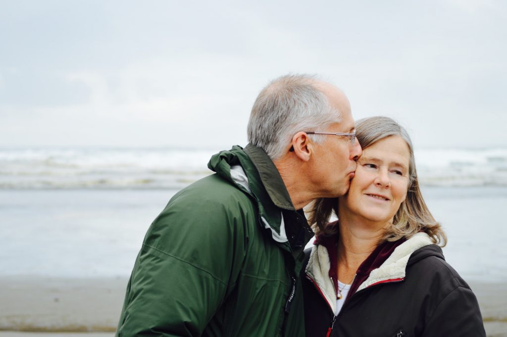 elderly man kissing woman